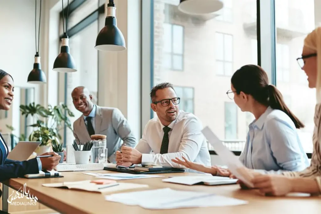 Team of professionals discussing documents and collaborating during a business meeting in a modern office.