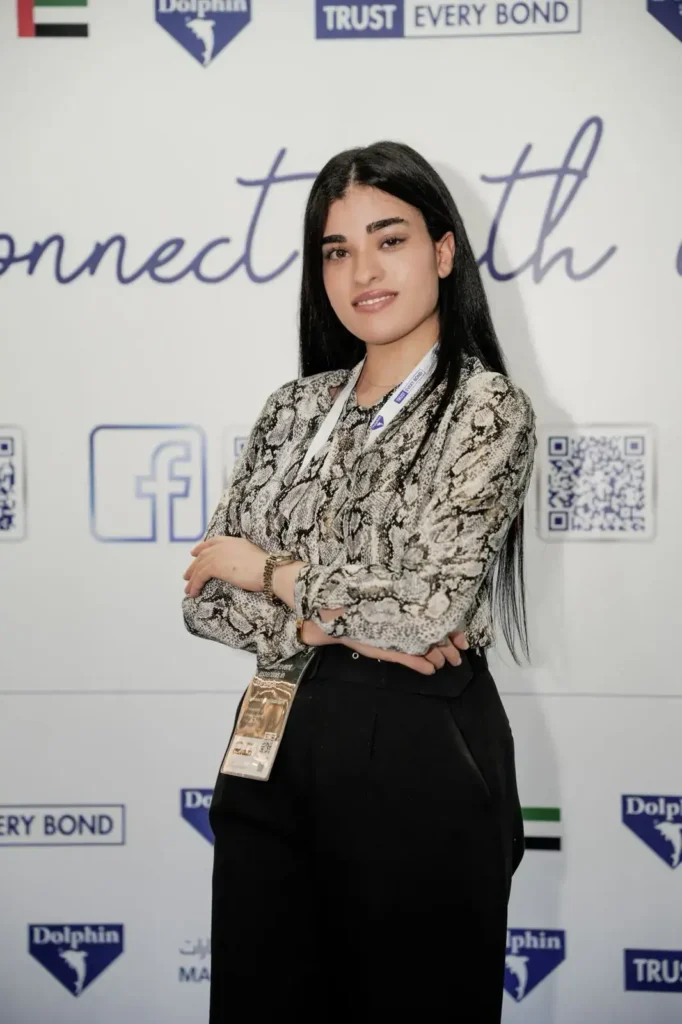 Hostess Provider for Gulfood Exhibition wearing badge and formal attire with confident pose