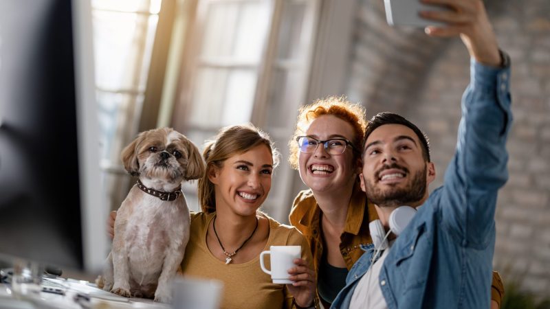 group-of-happy-freelancers-with-a-dog-taking-selfi-2022-09-23-23-13-05-utc-scaled-1