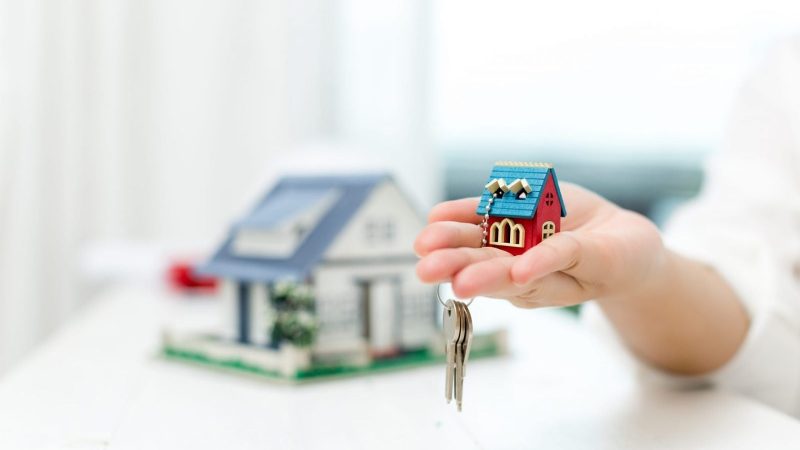 real-estate-agent-with-house-model-keys-1-scaled-1-scaled-1