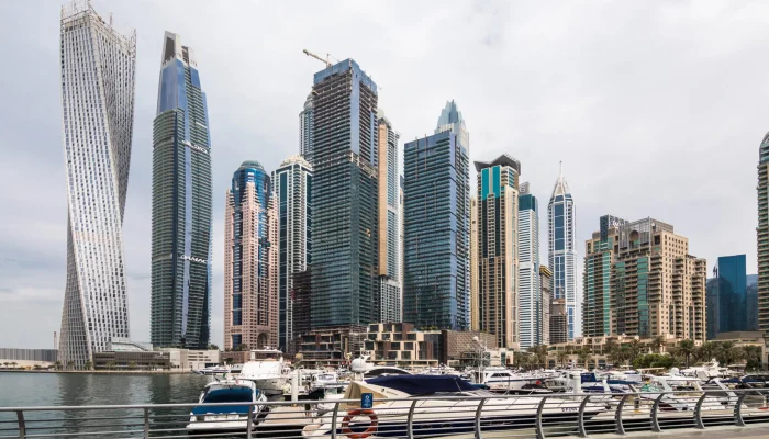 DUBAI, UAE - OCTOBER 2018: View of modern skyscrapers shining in sunrise lights in Dubai Marina in Dubai.